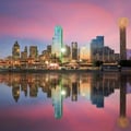 This image shows the downtown skyline of Dallas, Texas, reflected in water at sunset.