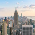 This image shows the iconic Empire State Building standing tall in the center of the Midtown Manhattan skyline in New York City.