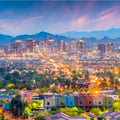The image appears to show the downtown skyline of Phoenix, Arizona, at dusk.
