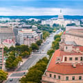This image shows an elevated view looking down Pennsylvania Avenue toward the United States Capitol Building in Washington, D.C.