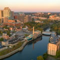 This aerial view shows the cityscape of Wilmington, Delaware, looking over the Christina River at sunrise.