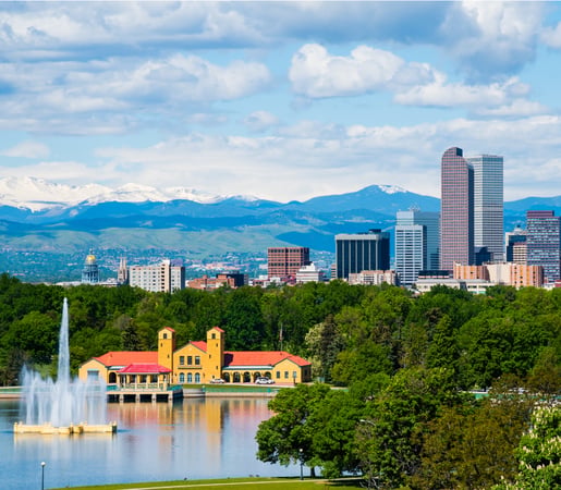 The image shows the Denver skyline and the Rocky Mountains viewed from City Park in Denver, Colorado.