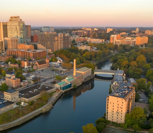 This aerial view shows the cityscape of Wilmington, Delaware, looking over the Christina River at sunrise.
